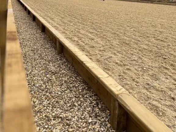 Our dressage arenas feature integrated boards, with an optional set-back fence, built for safety and function.