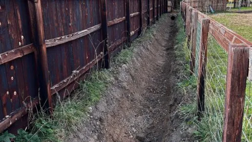 An open ditch between two fences