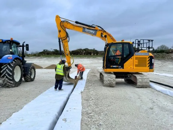 Digging drainage channels for an arena